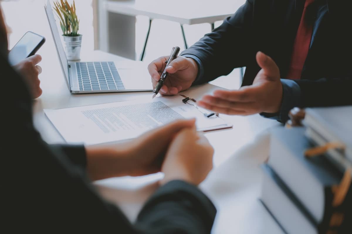 business agent explaining contract to couple, representing Charitable Remainder Trust
